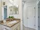 Bathroom featuring a granite-topped vanity, mirror, decorative items and neutral wall color at 1221 Dustin Rd, North Port, FL 34288