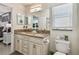 Bathroom with granite countertop, dual sinks, plenty of cabinet storage, and a toilet at 1221 Dustin Rd, North Port, FL 34288