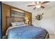 Bedroom with a statement wall, unique mirror decor, and a ceiling fan with light fixture at 1221 Dustin Rd, North Port, FL 34288