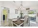 Bright dining room features a stylish chandelier and sliding glass doors to the patio at 1221 Dustin Rd, North Port, FL 34288
