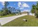 Charming single-story home with a well-manicured lawn, concrete driveway, and a two-car garage at 1221 Dustin Rd, North Port, FL 34288