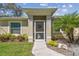 Welcoming front entrance with a screened door, and decorative landscaping at 1221 Dustin Rd, North Port, FL 34288