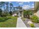 Inviting entrance with a well maintained lawn, landscaped garden and walkway leading to the front door at 1221 Dustin Rd, North Port, FL 34288