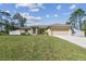 Charming single-story home with a well-manicured lawn and a two-car garage at 1221 Dustin Rd, North Port, FL 34288