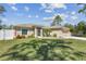 Charming one-story home with a well-maintained lawn and a two-car garage at 1221 Dustin Rd, North Port, FL 34288