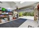 Garage with door opening to the driveway and equipped with storage solutions and lawn care equipment at 1221 Dustin Rd, North Port, FL 34288