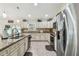 Well-lit kitchen features granite countertops, stainless steel appliances, and ample cabinet space at 1221 Dustin Rd, North Port, FL 34288