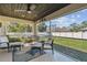 Comfortable screened lanai offers ample seating and serene views of the well-kept backyard at 1221 Dustin Rd, North Port, FL 34288