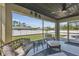 Relaxing screened lanai showcasing comfortable seating and views of the fenced backyard at 1221 Dustin Rd, North Port, FL 34288