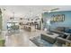 Open-concept living space featuring tile floors, kitchen island, dining table, and comfortable furnishings at 1221 Dustin Rd, North Port, FL 34288