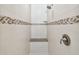Shower with white subway tile, mosaic accent, a built-in seat and handheld sprayer at 1221 Dustin Rd, North Port, FL 34288