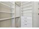 Bright walk-in closet with many shelves, drawers and hanging storage space for organization at 1221 Dustin Rd, North Port, FL 34288