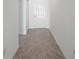 Interior hallway with tile flooring, white walls and door with knob at 1352 Abscott St, Port Charlotte, FL 33981