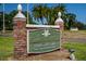 Dunedin Golf Club entrance sign with brick pillars, landscaped surroundings and welcoming text at 1366 Carlisle Ct, Dunedin, FL 34698