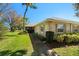 Well-maintained home with lush landscaping, a walkway, and neutral exterior at 1366 Carlisle Ct, Dunedin, FL 34698