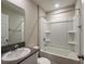 Bathroom featuring a single sink vanity, mirror, and a tub with shower at 14777 Summer Branch Dr, Lithia, FL 33547