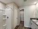 Bathroom featuring a shower and double sink vanity with walk-in closet access at 14777 Summer Branch Dr, Lithia, FL 33547