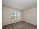 Neutral bedroom featuring two windows providing natural light and plush carpet at 14777 Summer Branch Dr, Lithia, FL 33547
