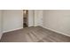 Bedroom with neutral walls and carpet featuring a bathroom entrance and a closet at 14777 Summer Branch Dr, Lithia, FL 33547