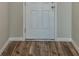 Bright entryway showcasing stylish wood-look floors and a classic white door at 14777 Summer Branch Dr, Lithia, FL 33547
