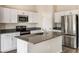 Well-appointed kitchen with stainless steel appliances, gray countertops, and ample cabinet space at 14777 Summer Branch Dr, Lithia, FL 33547