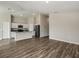 An open floor plan featuring wood-style flooring and a modern kitchen with stainless steel appliances at 14777 Summer Branch Dr, Lithia, FL 33547
