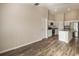 Inviting living room showcasing an open floorplan with hardwood floors and white kitchen cabinets at 14777 Summer Branch Dr, Lithia, FL 33547