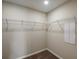 Spacious walk-in closet featuring carpeted floors and metal shelving at 14777 Summer Branch Dr, Lithia, FL 33547