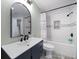 Bathroom featuring a tub-shower combo and decorative mirror at 1552 Glen Hollow N Ln, Dunedin, FL 34698