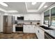 Well-lit kitchen featuring stainless steel appliances, granite countertops, and white subway tile backsplash at 1552 Glen Hollow N Ln, Dunedin, FL 34698