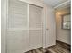 Bedroom features wood-look flooring, closet with louvered doors and a window for natural light at 1608 Thrush Dr, Zephyrhills, FL 33540