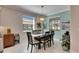 Elegant dining room with a dark wood table and stylish chandelier at 16817 Whisper Elm St, Wimauma, FL 33598