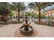 The condo courtyard has a central tiered fountain, tables, chairs, and palm trees at 1810 E Palm Ave # 5222, Tampa, FL 33605