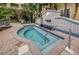 Hot tub and fountain with elegant tile work surrounded by landscaped grounds at 1810 E Palm Ave # 5222, Tampa, FL 33605