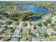 A high angle view of a residential neighborhood with lake views and mature trees at 19826 Wyndham Lakes Dr, Odessa, FL 33556