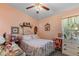 Bedroom featuring floral bedding, a ceiling fan, and personal touches creating a cozy atmosphere at 19826 Wyndham Lakes Dr, Odessa, FL 33556