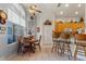 Eat-in kitchen with tile floor, wooden breakfast table, seating and lots of natural light from a large window at 19826 Wyndham Lakes Dr, Odessa, FL 33556