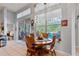 Cozy dining area with wooden table, tile floors, and backyard views of the pool at 19826 Wyndham Lakes Dr, Odessa, FL 33556