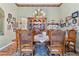 Elegant dining room with classic wooden furniture, a vintage chandelier, and Gathering photo gallery wall at 19826 Wyndham Lakes Dr, Odessa, FL 33556