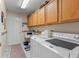 Efficient laundry room with modern appliances and overhead cabinets for ample storage at 19826 Wyndham Lakes Dr, Odessa, FL 33556