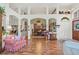 Open-concept living area with hardwood floors, high ceilings, and bright natural light at 19826 Wyndham Lakes Dr, Odessa, FL 33556
