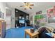 Spacious living room featuring a TV, fan, and a large window for ample natural light at 19826 Wyndham Lakes Dr, Odessa, FL 33556