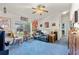 Inviting living room with blue carpet, a comfortable couch, ceiling fan, and bright natural light at 19826 Wyndham Lakes Dr, Odessa, FL 33556