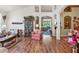 Bright living space showcasing hardwood flooring, high ceilings, and an open layout at 19826 Wyndham Lakes Dr, Odessa, FL 33556