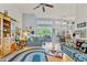 Comfortable living room featuring large windows and an open layout to the dining area at 19826 Wyndham Lakes Dr, Odessa, FL 33556