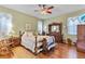 Cozy main bedroom with hardwood floors, a comfortable queen-sized bed, and charming wooden furniture at 19826 Wyndham Lakes Dr, Odessa, FL 33556