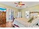 Bright main bedroom with access to a patio, en-suite bathroom, and a quaint, inviting aesthetic at 19826 Wyndham Lakes Dr, Odessa, FL 33556
