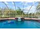 The pool and spa offer a relaxing oasis with a picturesque view of the serene backyard pond at 19826 Wyndham Lakes Dr, Odessa, FL 33556