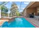 The pool and spa are situated within a screened enclosure and provide a private backyard retreat at 19826 Wyndham Lakes Dr, Odessa, FL 33556