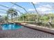 Screened-in pool area with waterfall feature and beautiful waterfront views at 19826 Wyndham Lakes Dr, Odessa, FL 33556